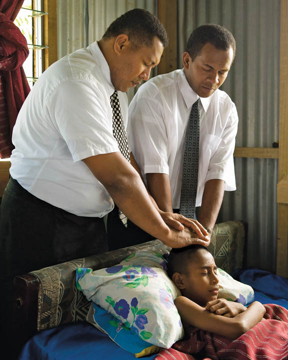 Mormon priesthood holder blessing the sick young man